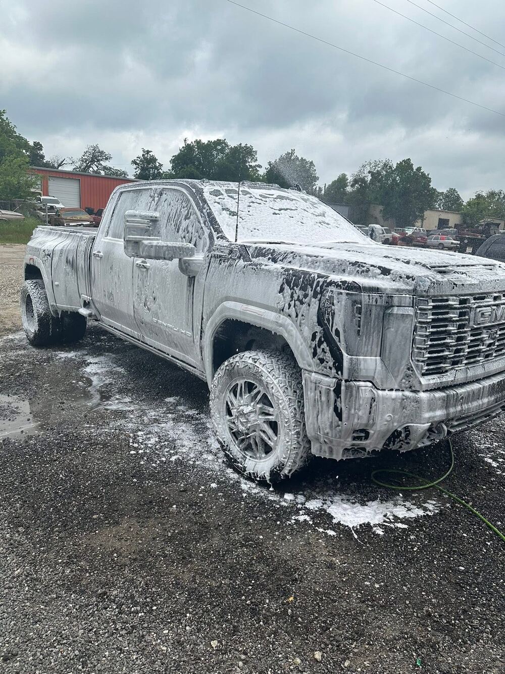 GMC Denali HD dually covered in foam during a wash